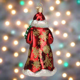Decorative Christmas ornament of a Santa Claus figure with gold snowflakes on a red coat.
