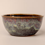 Stoneware bowl with a textured surface on a beige background