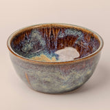 Ceramic bowl with textured surface on a beige background