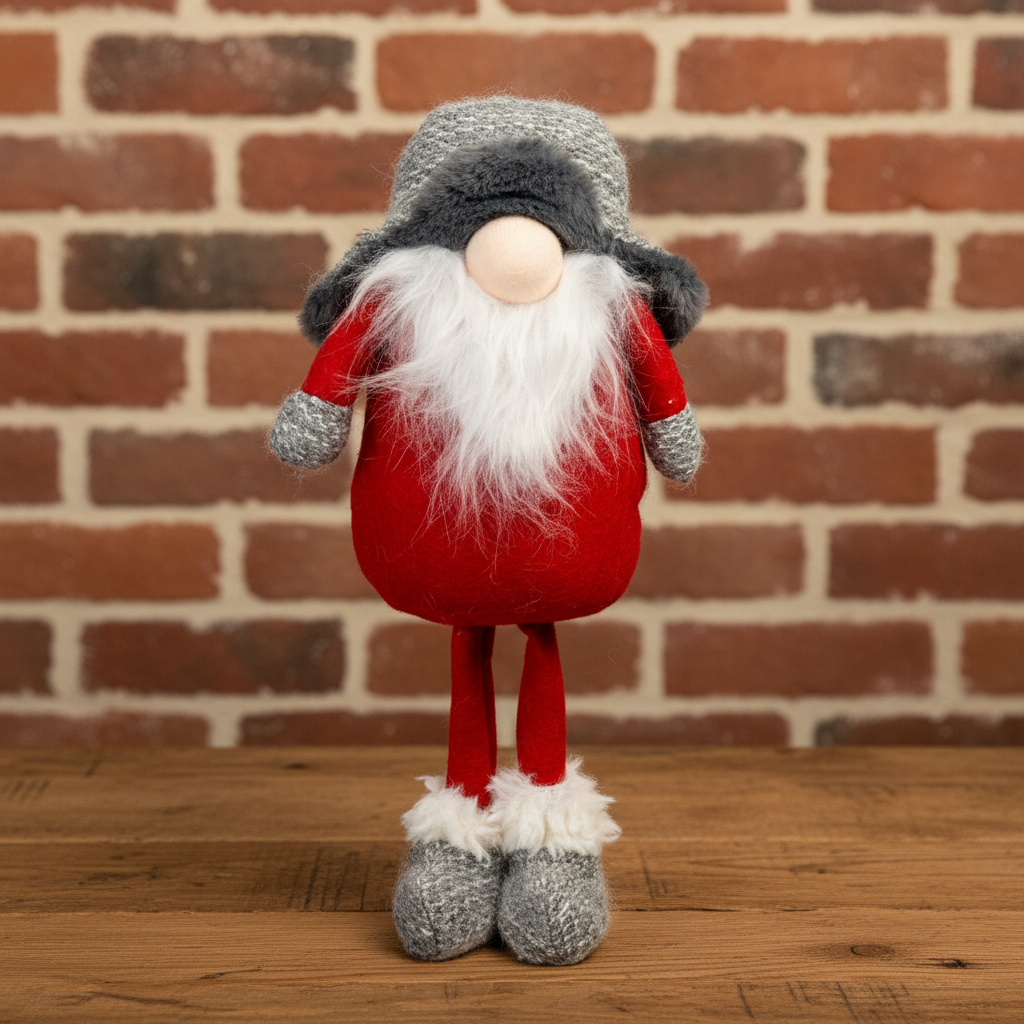 Gnome figurine with red outfit and gray hat against a brick wall background