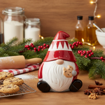 Decorative gnome figure on a kitchen counter with cookies and spices