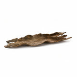 Decorative piece of metal shaped like driftwood on a white background
