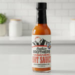 Bottle of Beehive Brothers Habanero Hot Sauce on a kitchen counter