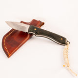 Knife with leather sheath and rope lanyard on a white background