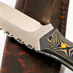 Close-up of a knife with a wooden handle on a leather sheath