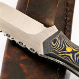 Close-up of a knife with a wooden handle on a leather sheath