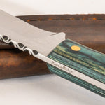 close up of hand crafted knife with wooden handle and leather sheath on white background