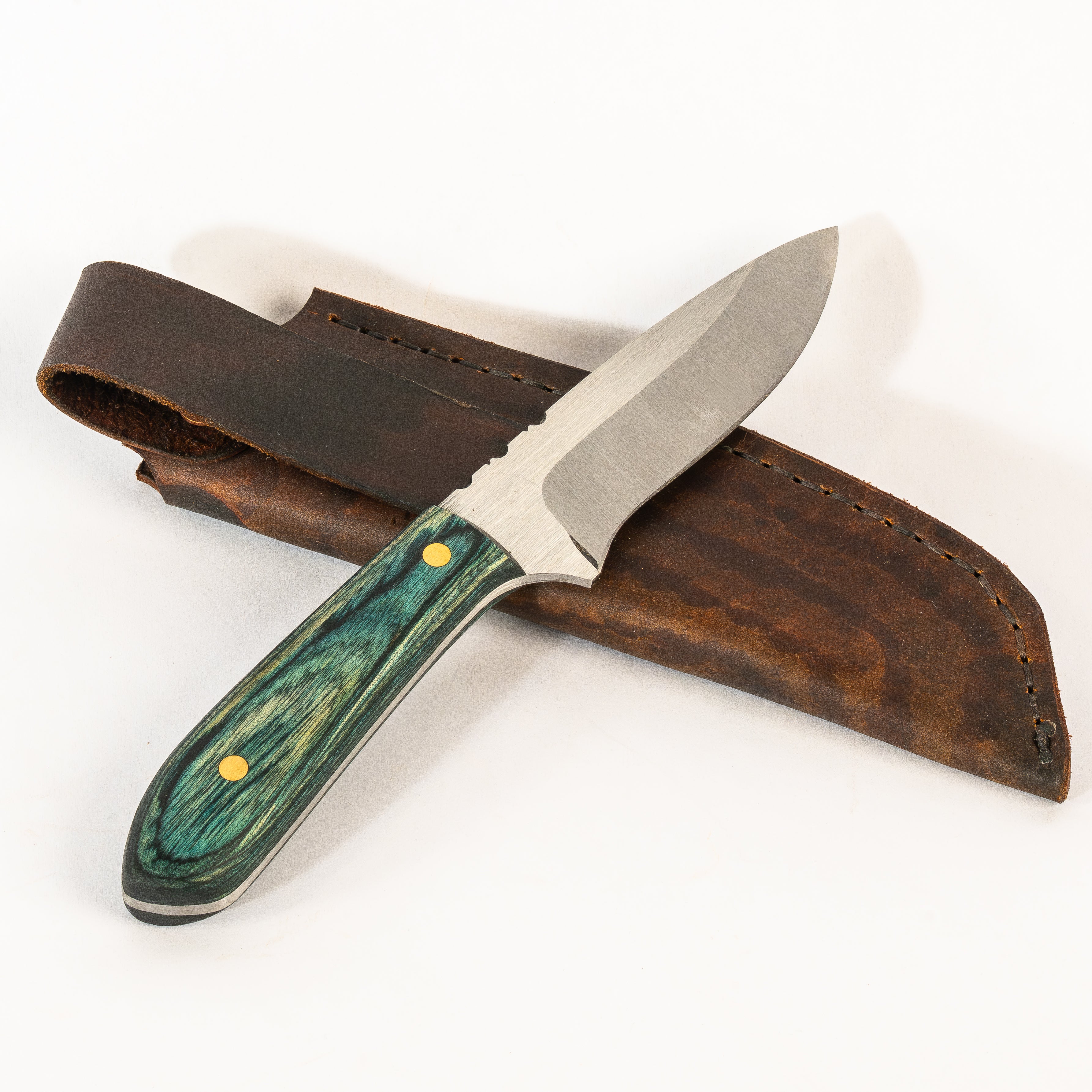 hand crafted knife with wooden handle and leather sheath on white background