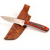 Knife with a wooden handle and leather sheath on a white background
