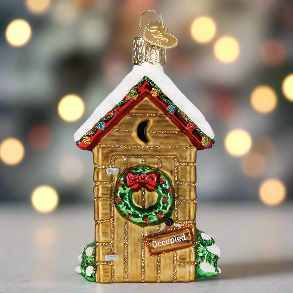 Decorative Christmas birdhouse ornament with a wreath and 'Occupied' sign on a white background
