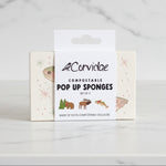 Packaging of Corvidae compostable pop-up sponges on a wooden surface