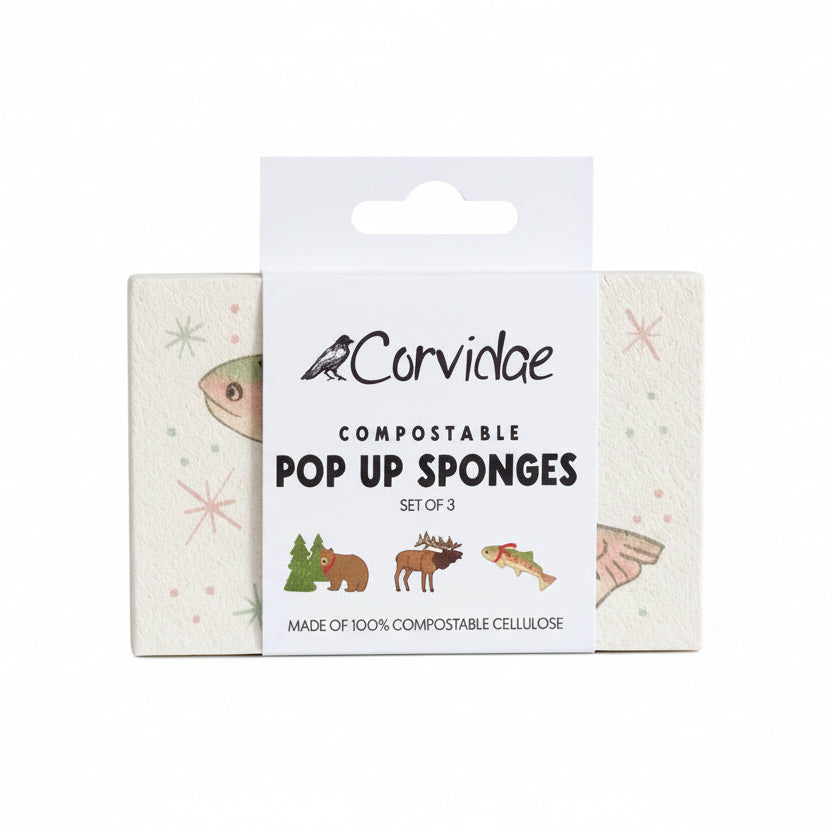 Packaging of Corvidae compostable pop-up sponges on a wooden surface