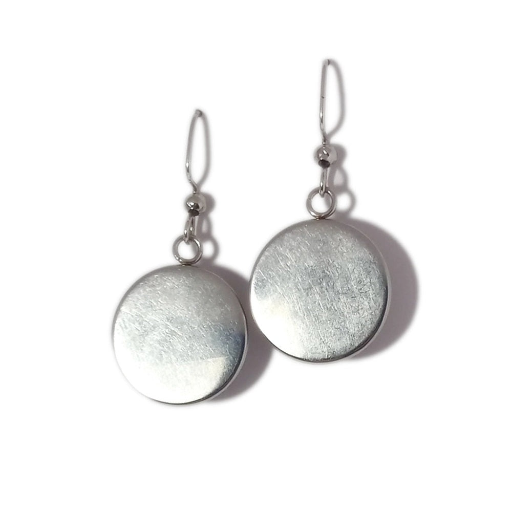 Pair of silver round earrings on a white background