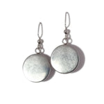 Pair of silver round earrings on a white background