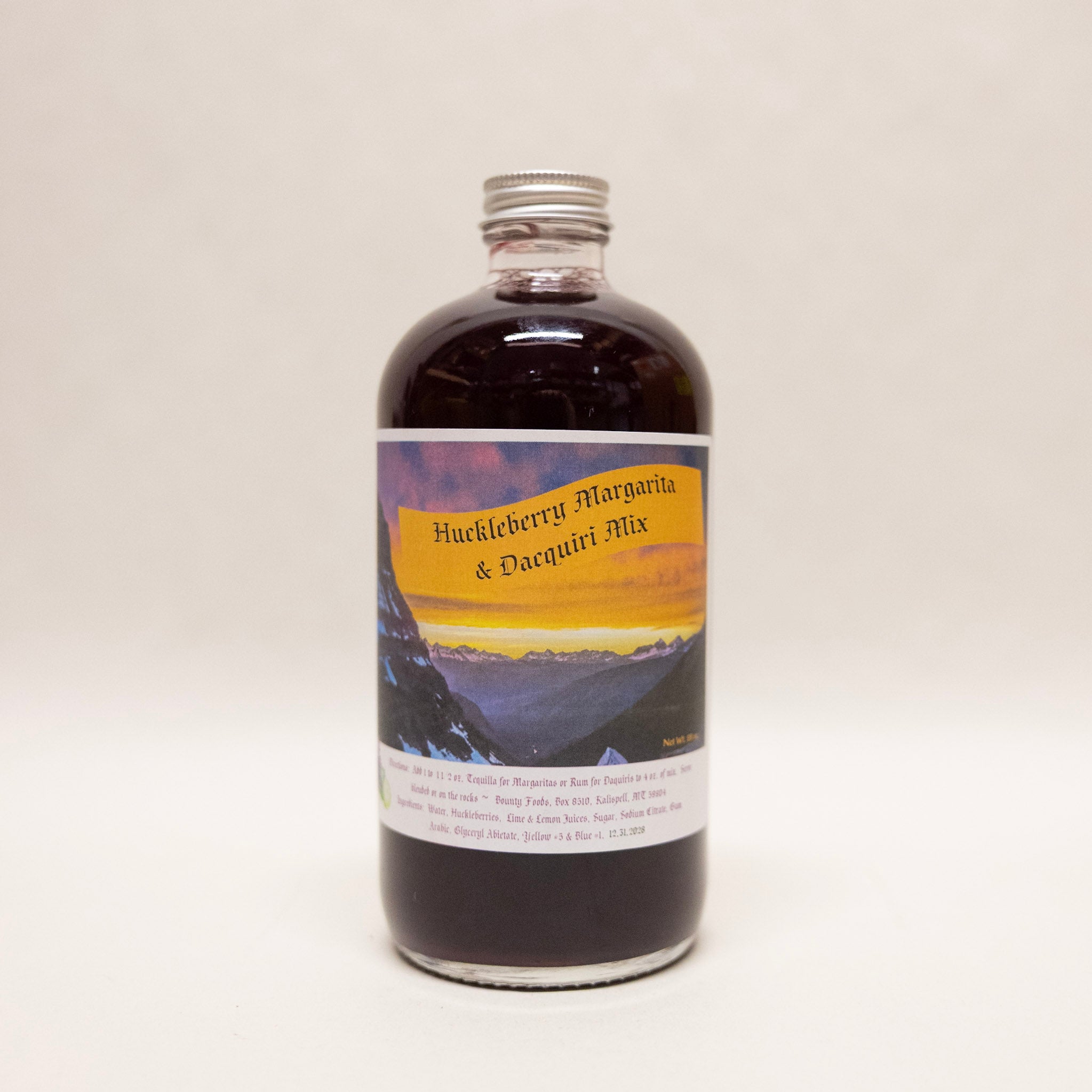 Bottle of Huckleberry Margarita & Daiquiri Mix with a scenic label on a white background