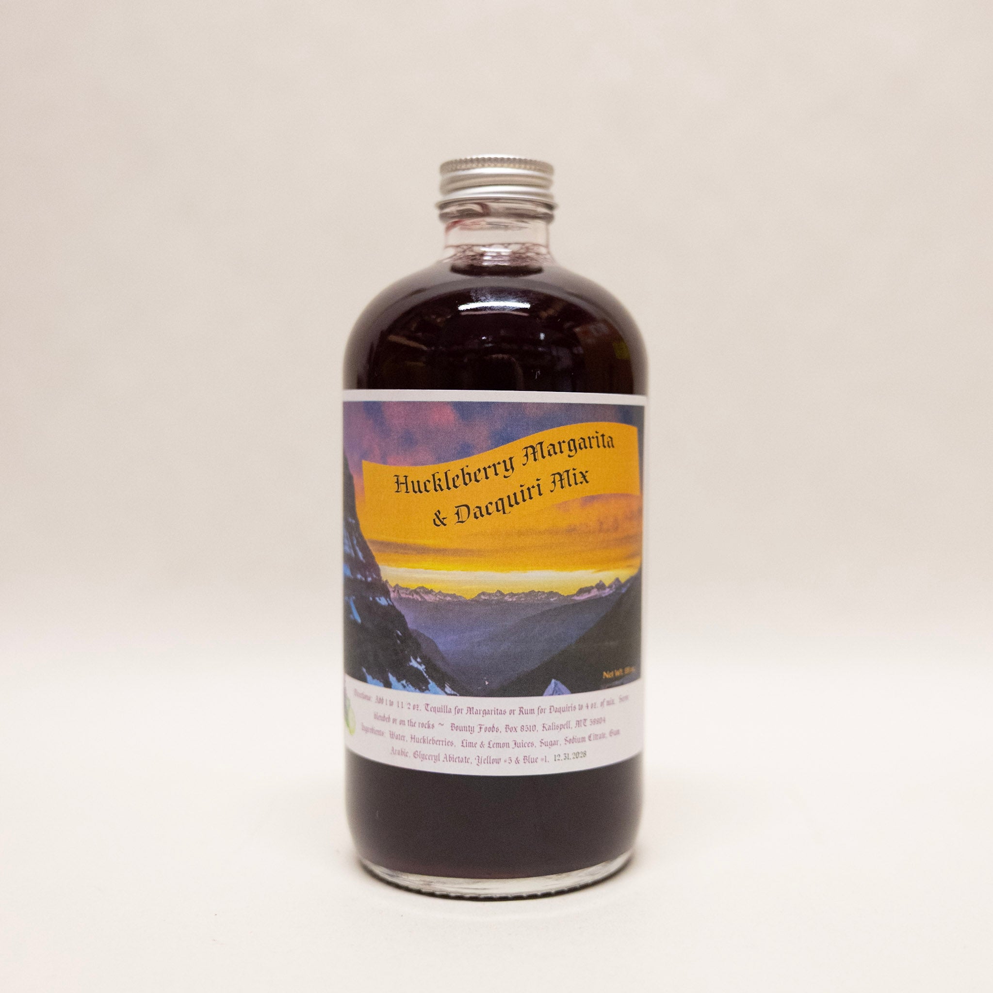 Bottle of Huckleberry Margarita & Daiquiri Mix with a scenic label on a white background