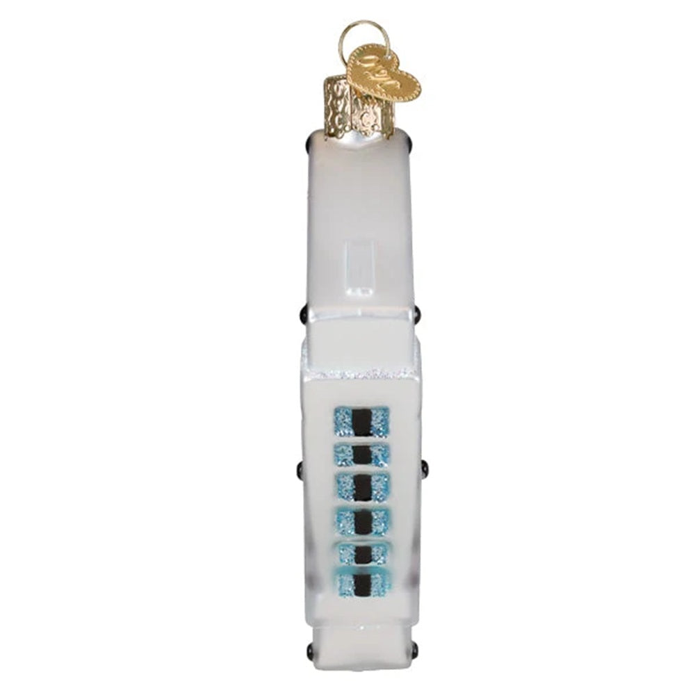 Decorative glass ornament resembling a white electronic device with blue and black buttons on a white background