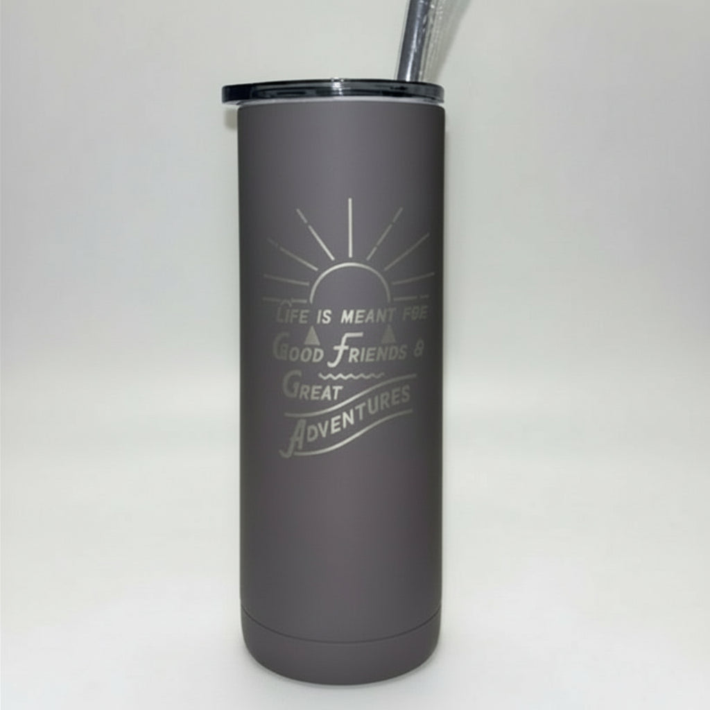 gray tumbler with a straw on a wooden surface