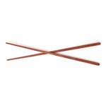 Pair of wooden chopsticks on a white background
