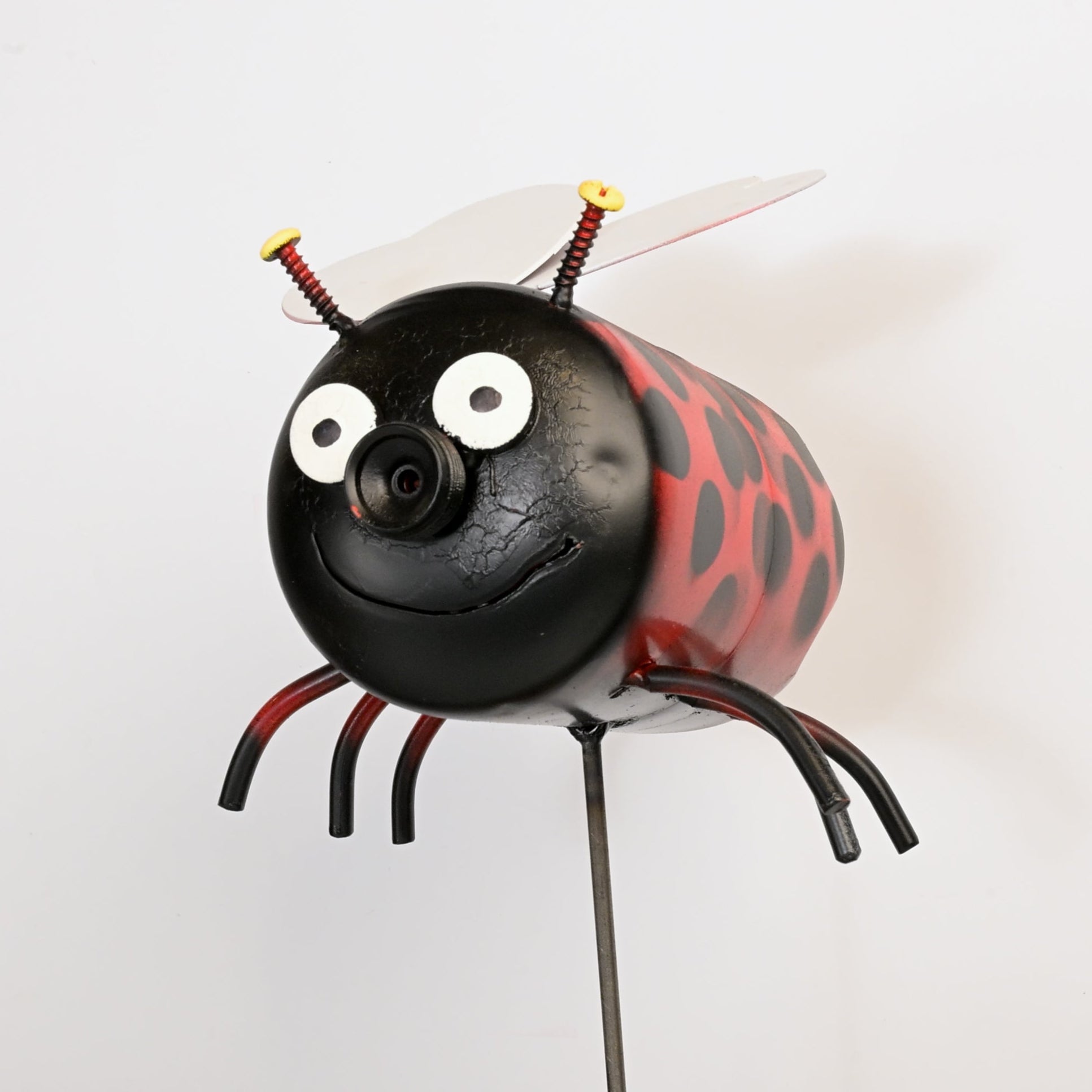 Metallic ladybug lawn ornament on a white background