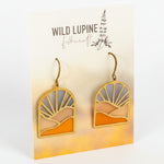 Pair of earrings on a 'Wild Lupine Folkcraft' branded card.
