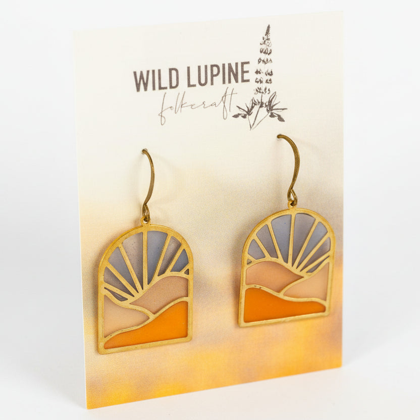 Pair of earrings on a 'Wild Lupine Folkcraft' branded card.