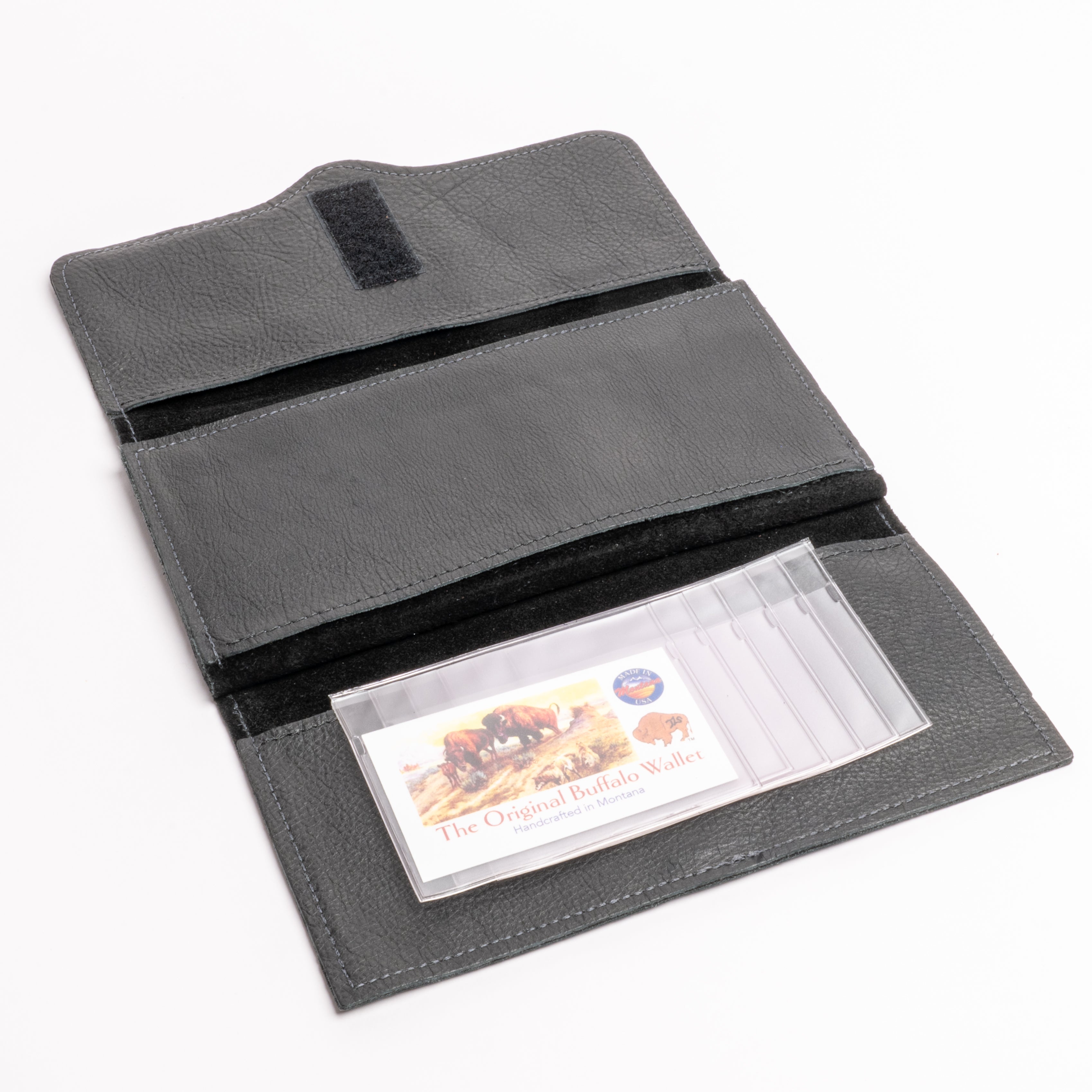 A dark gray textured leather wallet shown open on a white background, featuring a clear plastic card holder containing a buffalo-themed business card.