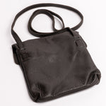 A black pebbled leather shoulder bag with a single adjustable strap, photographed on a clean white background.
