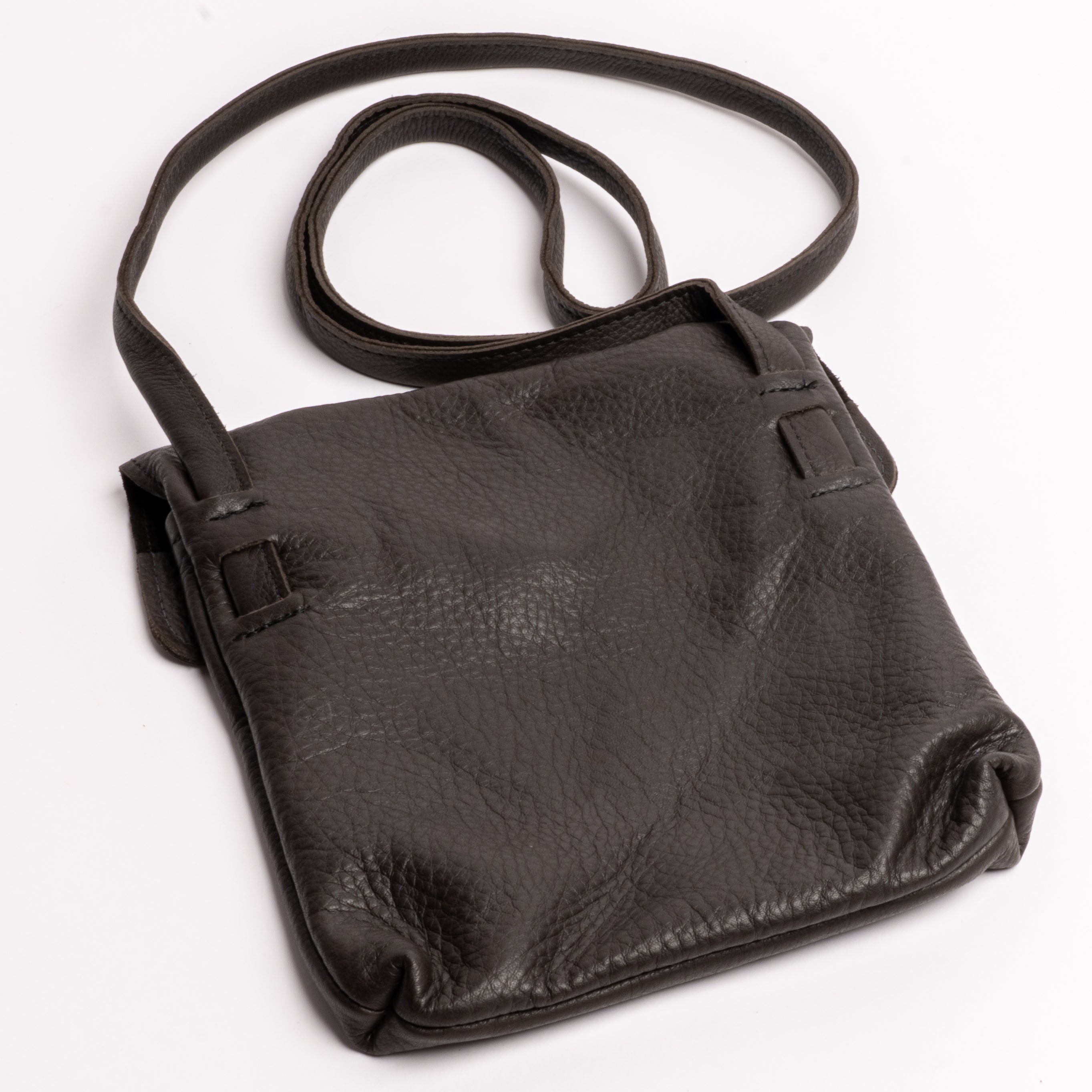 A black pebbled leather shoulder bag with a single adjustable strap, photographed on a clean white background.