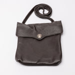 A dark brown pebbled leather crossbody bag with a flap closure and a silver-tone snap button, shown on a plain white background.