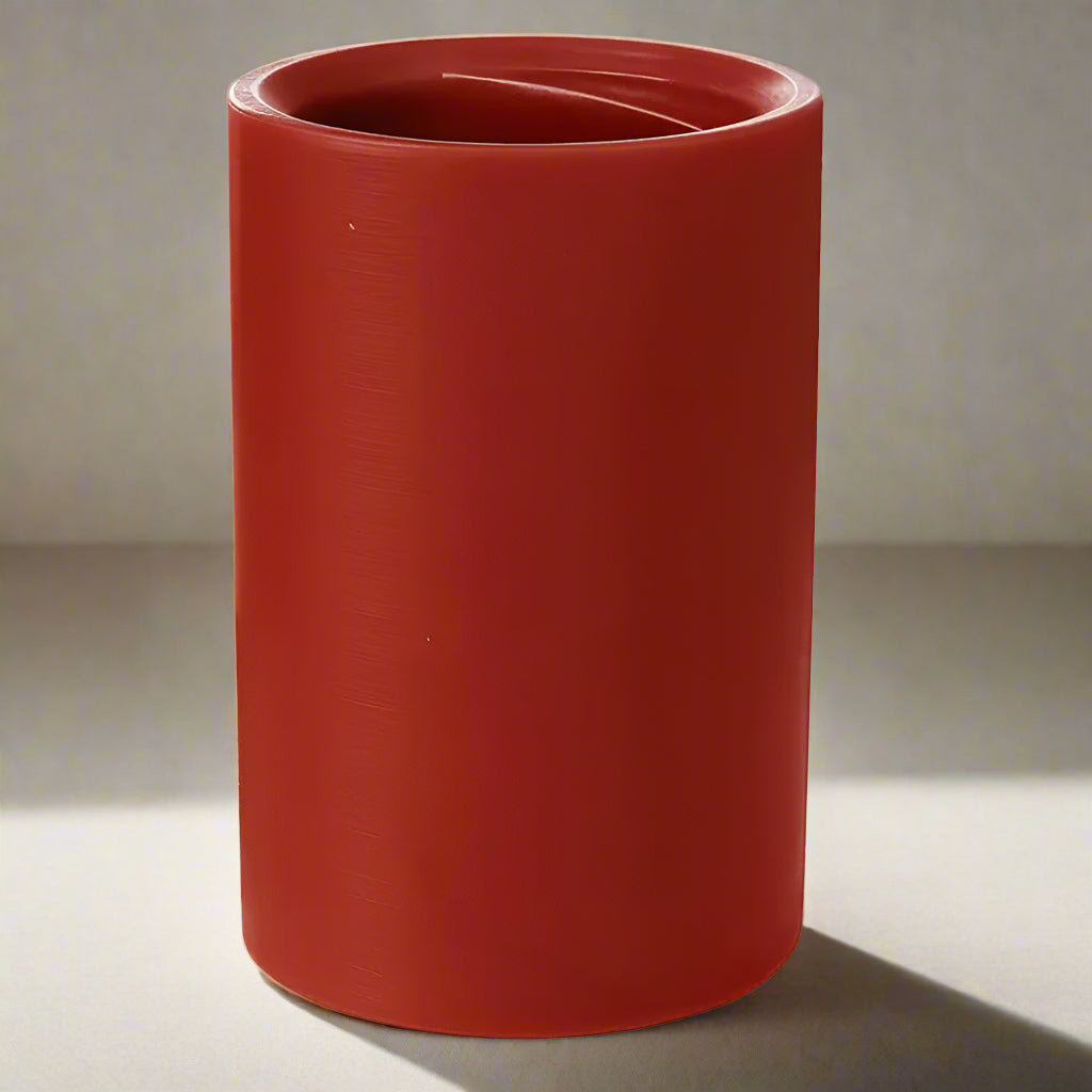 Red cylindrical candle on a white background