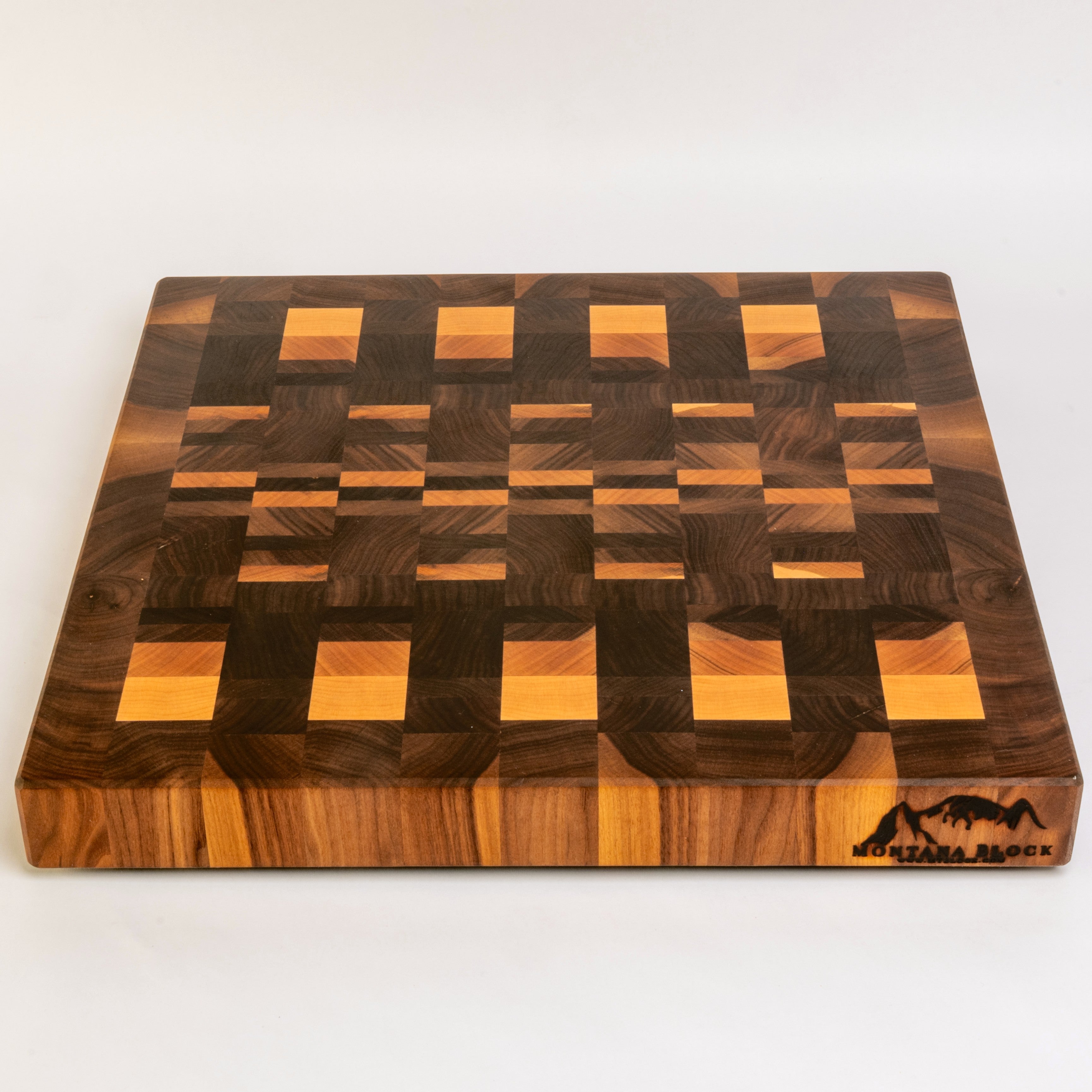 Wooden cutting board with a checkered pattern on a white background