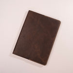 Brown leather notebook on a light gray background