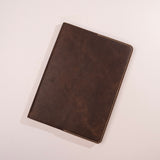 Brown leather notebook on a light gray background