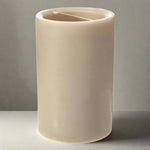 Beige candle with a wick on a white background