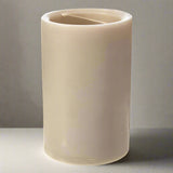 Beige candle with a wick on a white background