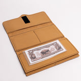 A tan leather wallet shown open on a white background, with a black hook-and-loop closure tab on the inside flap and a stack of U.S.