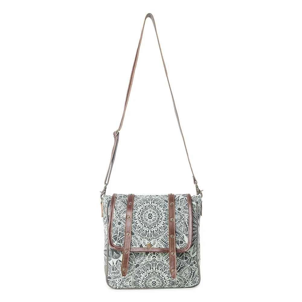 A square crossbody bag with a green and white mandala pattern, brown leather trim, and a brown shoulder strap, shown against a plain white background.