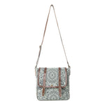 A square crossbody bag with a green and white mandala pattern, brown leather trim, and a brown shoulder strap, shown against a plain white background.