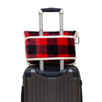 Red and black plaid luggage seat on a suitcase with a white background