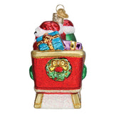 Decorative Christmas ornament of a red sleigh with Santa Claus and gifts on a white background