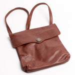 A brown leather shoulder bag with a flap closure and a single buffalo nickel button, shown on a plain white background.