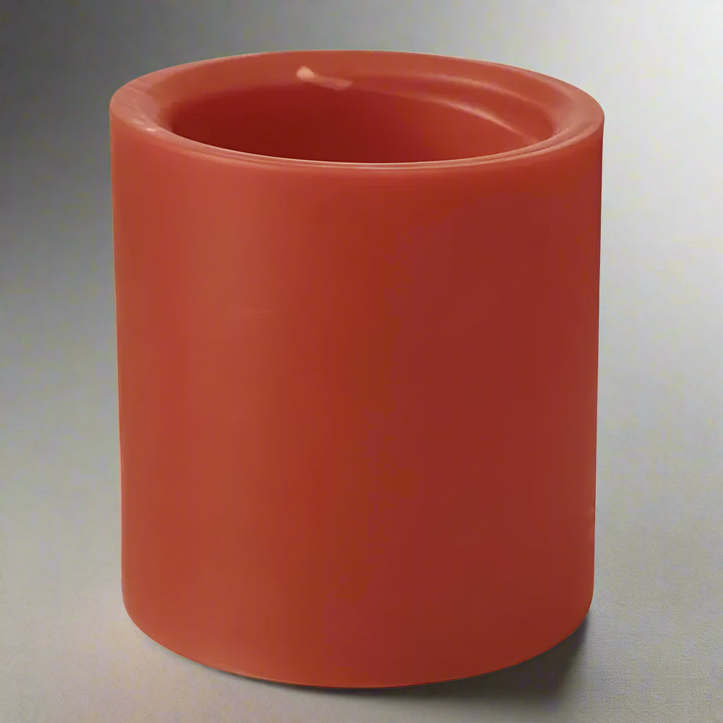 Red cylindrical candle on a white background