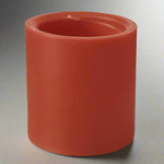 Red cylindrical candle on a white background