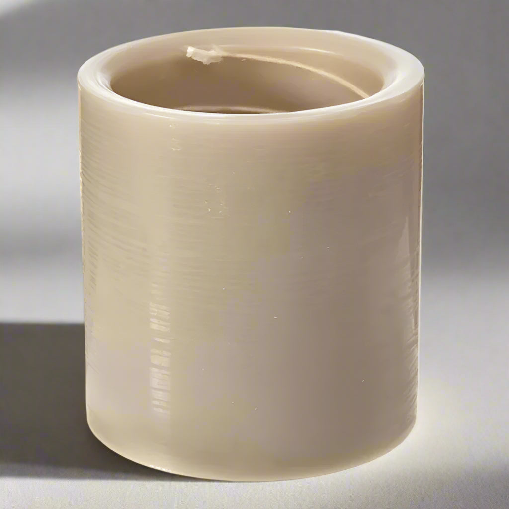 Beige cylindrical candle on a white background