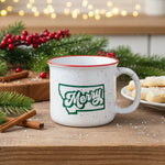 mug with a red rim and a design with the shape of montana that says merry on the inside