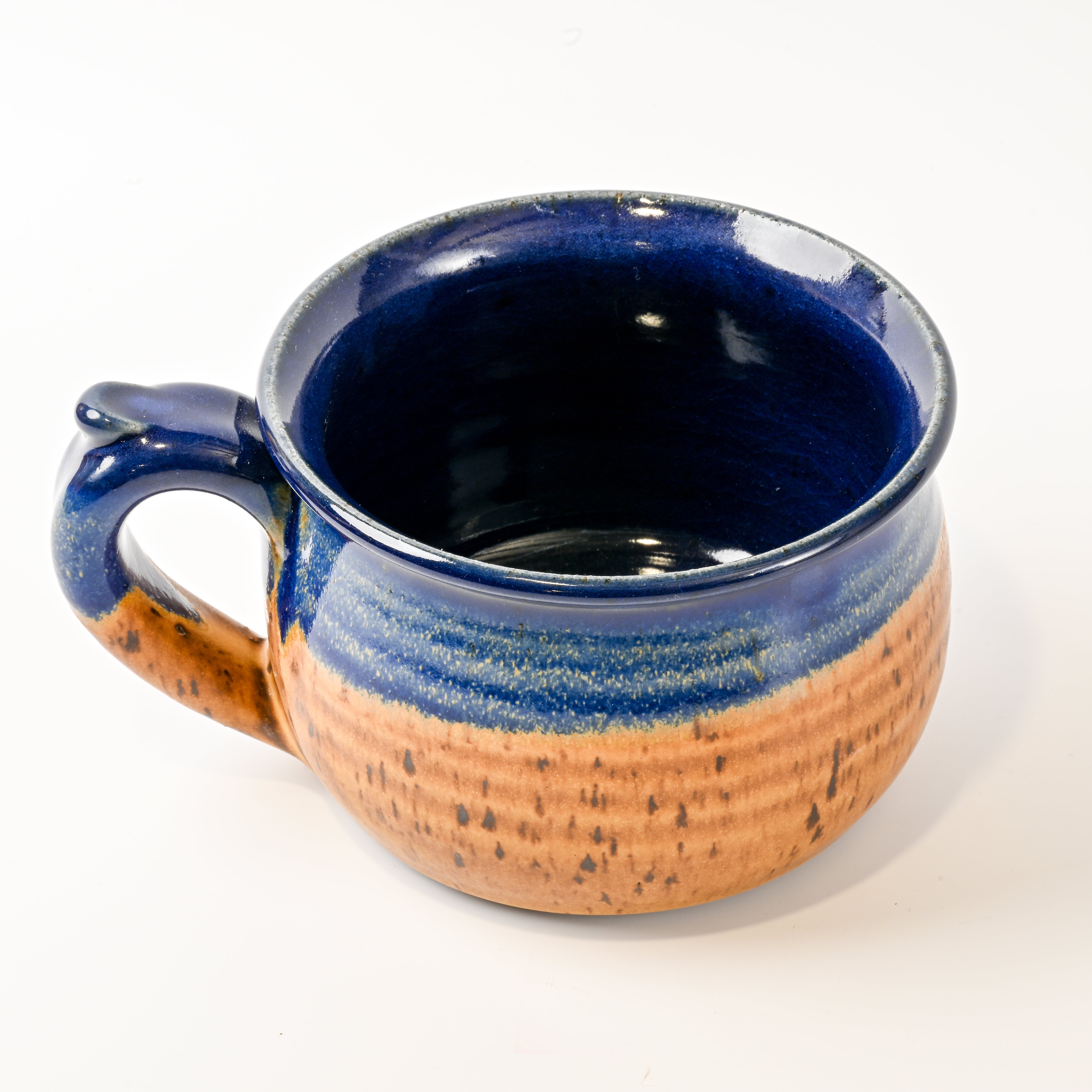 Ceramic mug with blue and brown glaze on a white background