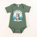 Green baby onesie with bear graphic and 'Montana' text on a white background