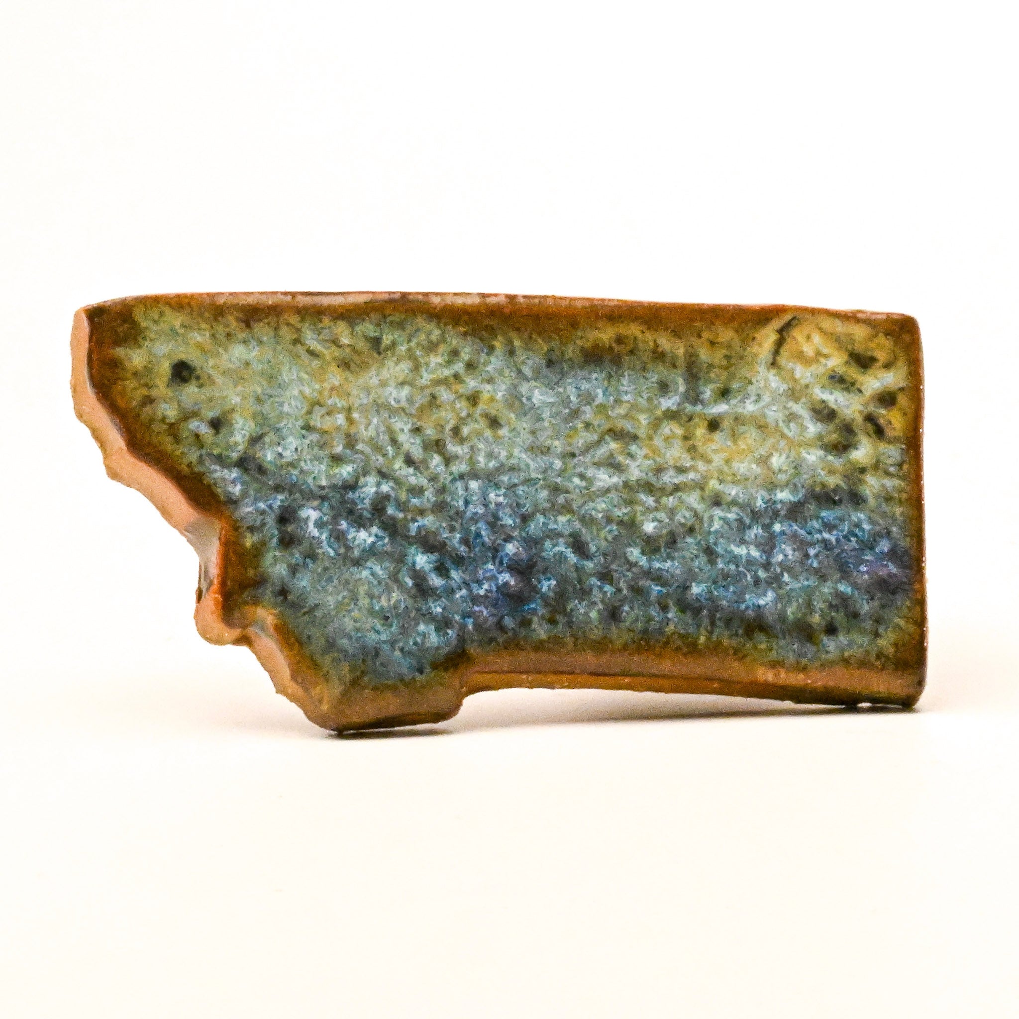 Ceramic magnet with textured surface on a white background