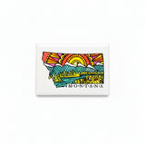 A rectangular white magnet featuring a colorful graphic of the state of Montana with a stylized sun, mountains, trees, and the word 'MONTANA' printed below, shown on a plain white background.